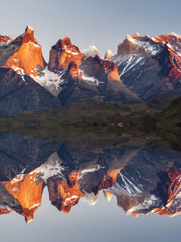 Mountain range Torres Paine reflected in clear water