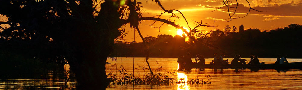 Canoe in the Amazon during sunset
