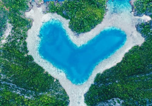 Coral reef and islands shaping water into a heart