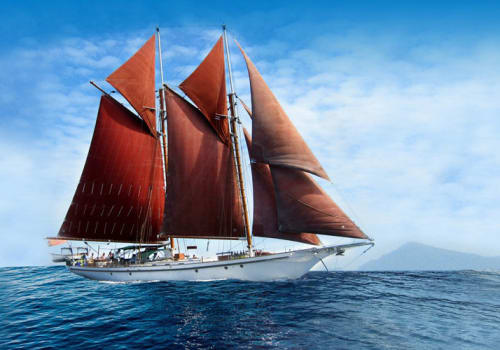 Sailboat with red sails at sea