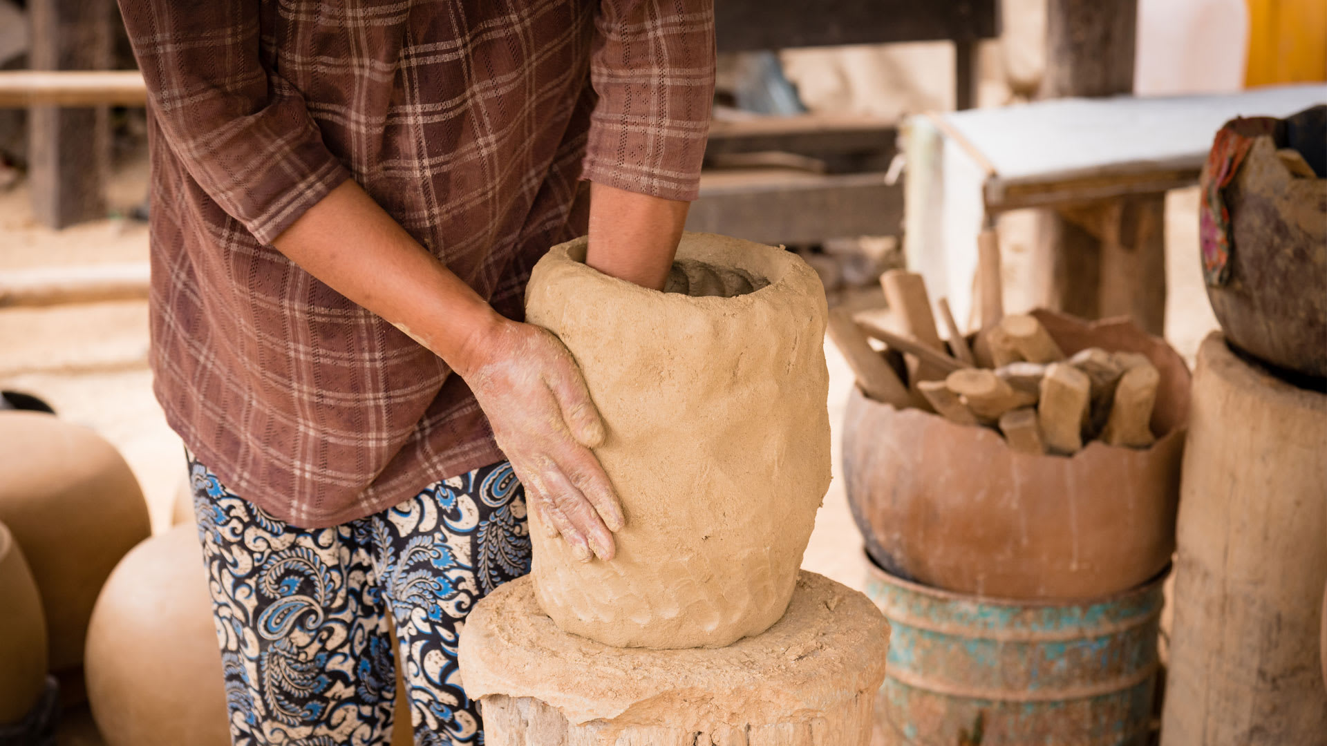 Artisans making pottery along the banks of the Mekong